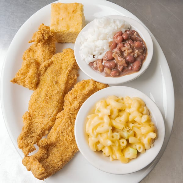 A plate of fried catfish, cornbread, rice and beans, and macaroni and cheese.
