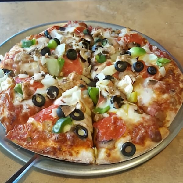 A whole Uncle Vinny's pizza with pepperoni, green peppers, onions, mushrooms, and black olives.